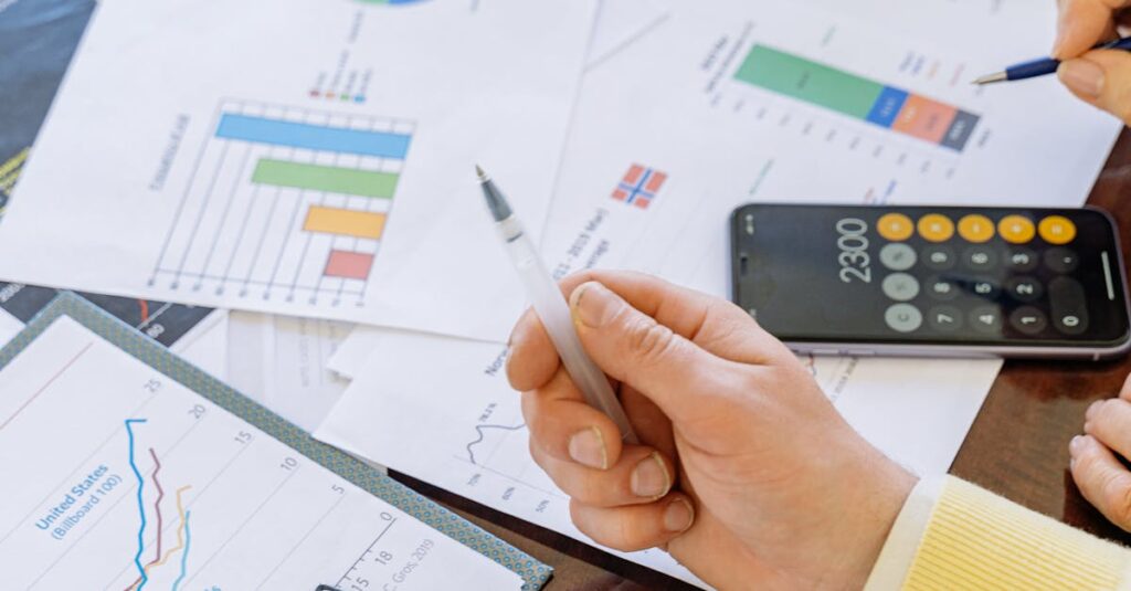 A close-up of businesspeople analyzing financial data and charts during a meeting.